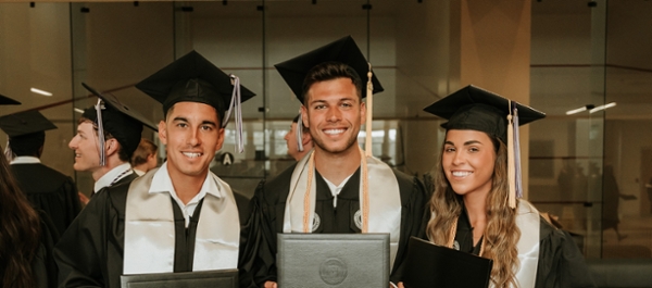 Student-athletes in graduation regalia at spring 2024 commencement. 